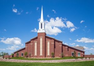 church against blue sky with white clouds