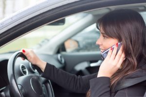 woman at the phone while driving